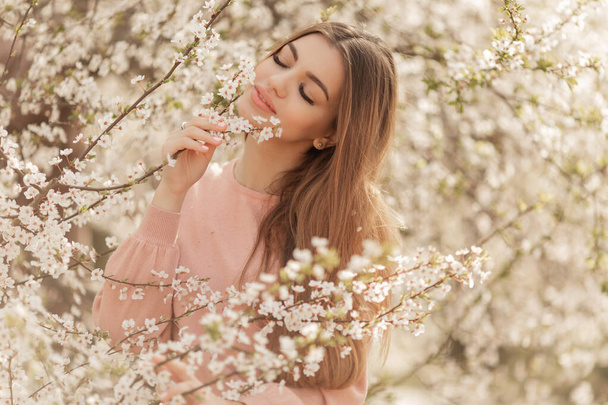 Beautiful natural woman during spring blossom time. - Photo, Image