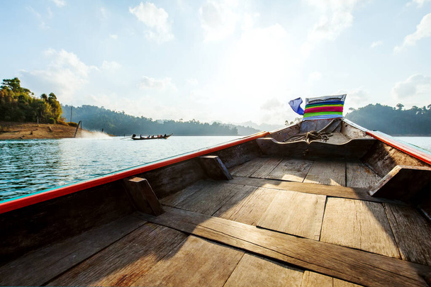 Wooden traditional thai longtail boat on Cheow Lan lake in Khao Sok National Park, Thailand - Photo, Image
