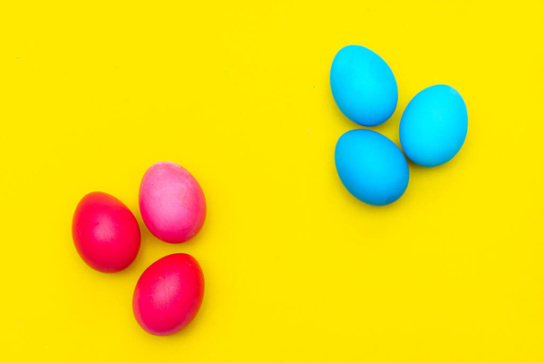 Colored painted eggs on a yellow background. Easter banner. Festive banner with place for text. Religious holiday. Painted eggs. - Photo, Image