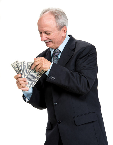 Senior zakenman houden groep dollars - Foto, afbeelding