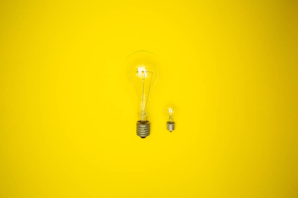 Due bulbi - grande e piccolo. sfondo giallo
 - Foto, immagini