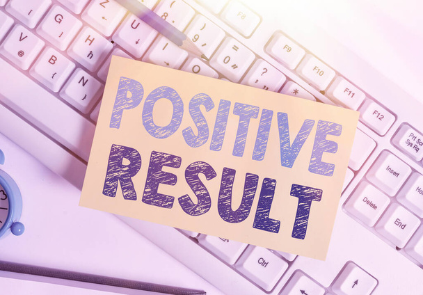 Writing note showing Positive Result. Business photo showcasing shows that someone has the disease, condition, or biomarker White pc keyboard note paper and paper clips above white background. - Photo, Image