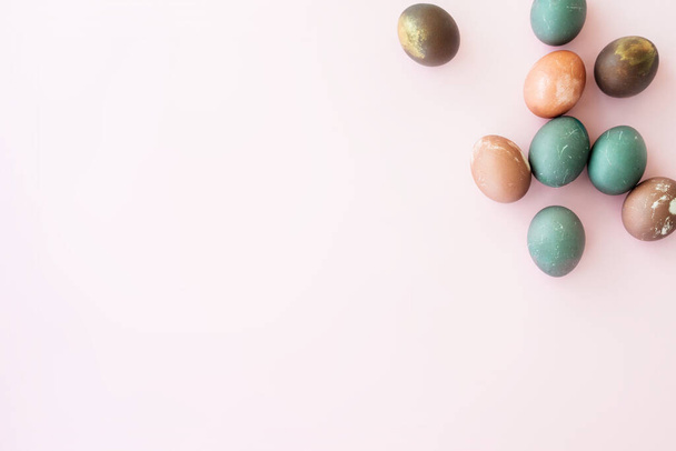 Collection of painted eggs on pink backround, copy space. Happy easter concept. Natural colorful egg, pastel natural color. - 写真・画像