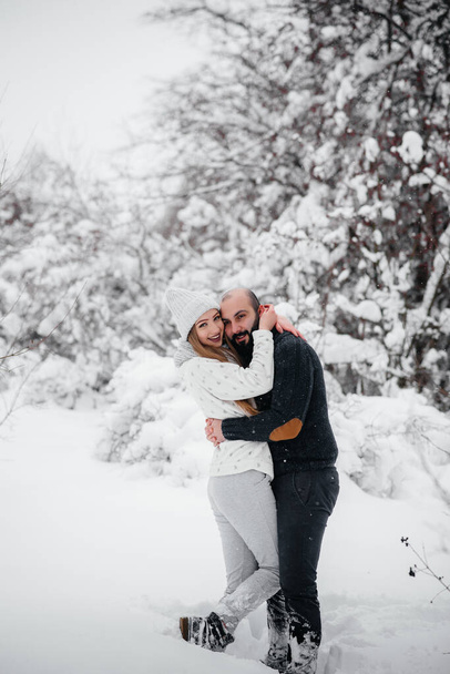 Couple playing with snow in the forest - Fotografie, Obrázek
