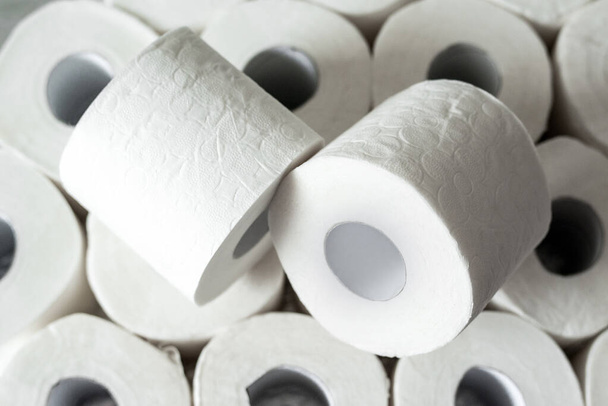 Toilet paper rolls background. Concept of lack of toilet paper in stores due to Covid-19, coronavirus, hygiene, panic. - Foto, immagini