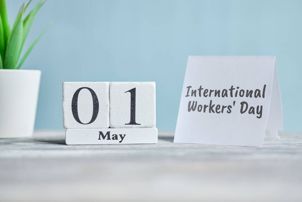 Міжнародний день робітників (англ. Holiday International Workers Day) - перший календар місяця Концепції дерев'яних блоків. Зачиніть.. - Фото, зображення