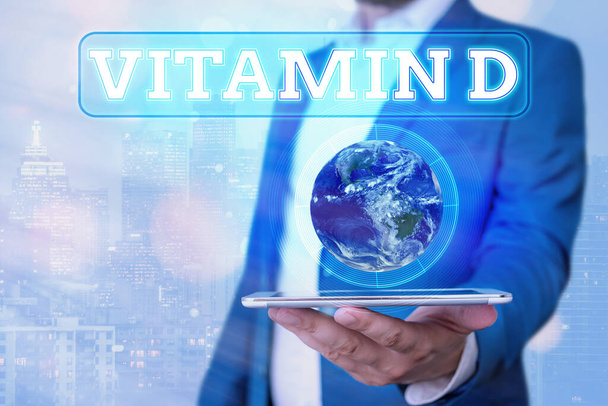 Text sign showing Vitamin D. Conceptual photo Nutrient responsible for increasing intestinal absorption Elements of this image furnished by NASA. - Photo, Image
