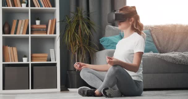 Attractive woman doing yoga exercises in virtual glasses - Video