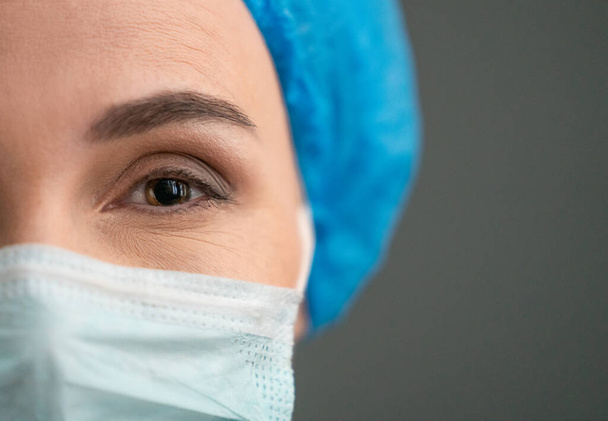 Womans eye In Protective Mask Looking At Camera - Photo, Image