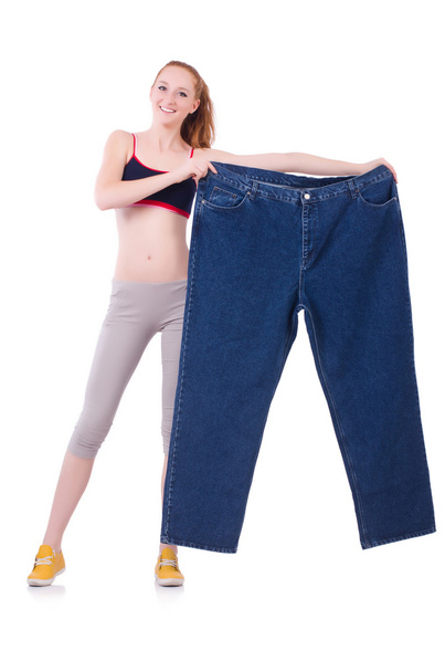 Woman with large jeans in dieting concept - 写真・画像