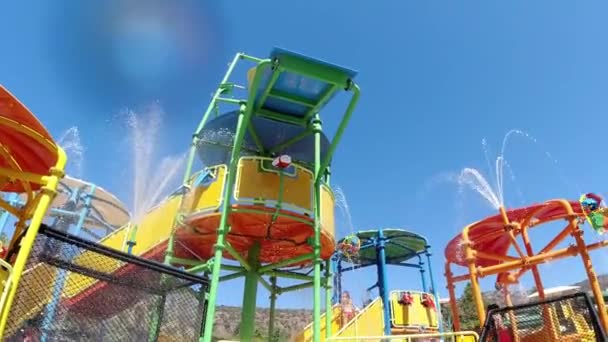 Spray of pouring water on the slides in water park. Aqua park background, Crete, Greece - Footage, Video