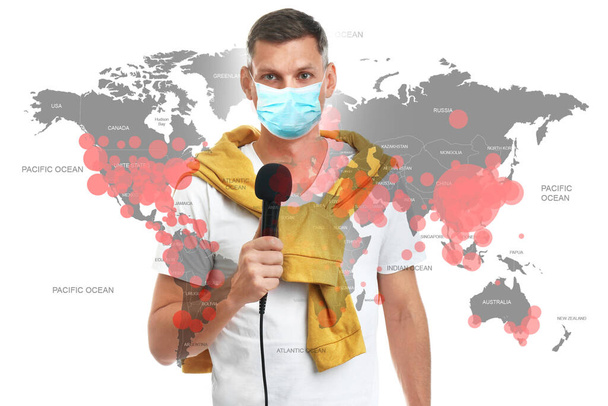 Journalist with medical mask presenting news during coronavirus outbreak. World map demonstrating spread of disease - Photo, image