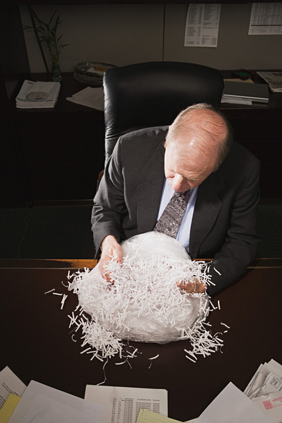 Mature businessman with paper shreddings - Photo, Image