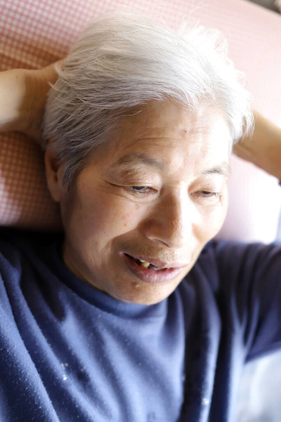 Dame âgée allongée sur le lit de soins infirmiers
 - Photo, image