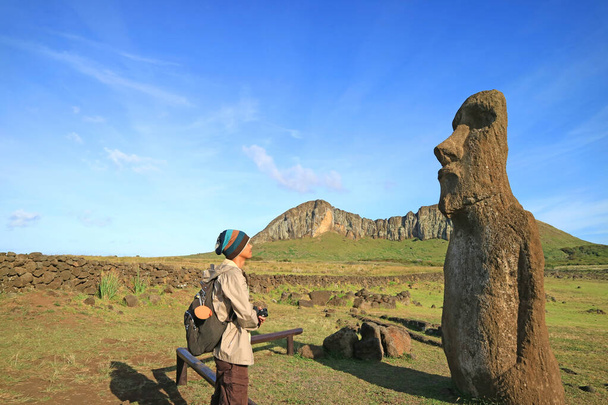 Reiziger onder de indruk van een enorme Moai standbeeld ruïnes op Paaseiland, Chili, Zuid-Amerika - Foto, afbeelding