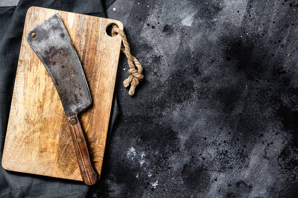Vintage butcher meat cleaver on concrete board. Black background. Top view. Copy space. - Фото, зображення