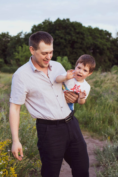Dad and little son on a walk in nature. Communication father and son. - Photo, Image