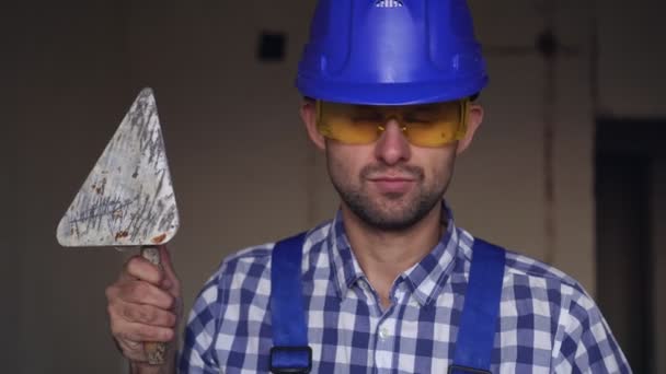 Portrait of a plasterer man. A male plasterer builder at a construction site - Footage, Video