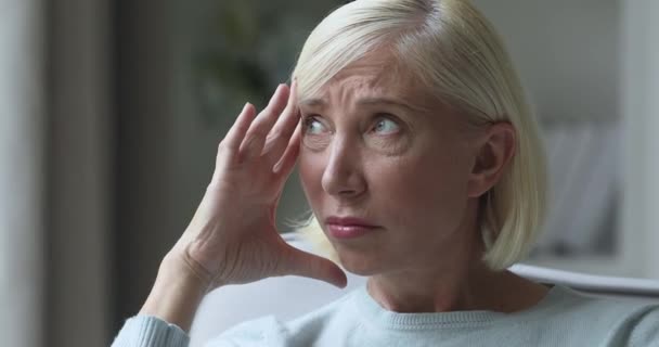 Unhappy stressed middle aged granny having high blood pressure migraine. - Felvétel, videó