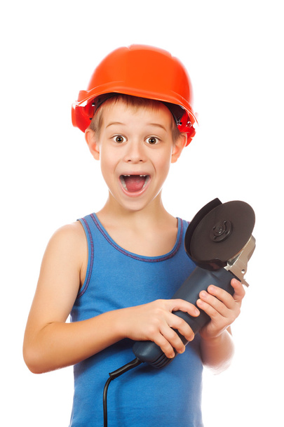 Little boy in a helmet with electric hammer - Fotó, kép