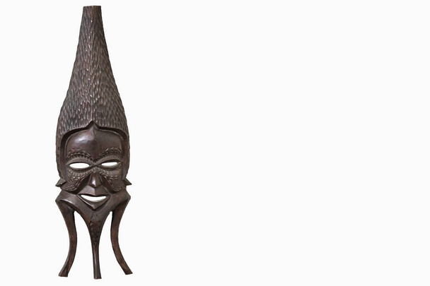 A traditional African Tribal Mask isolated against a white background with space for Copy Text to the right. - Photo, Image