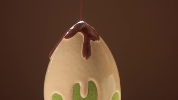 an egg shape blender sponge covered with light liquid foundation color and dark one pouring on - Footage, Video