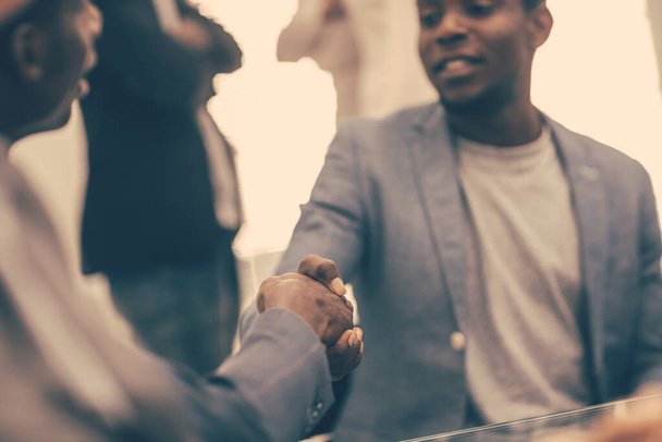 close up. young business partners shaking hands. - Photo, image