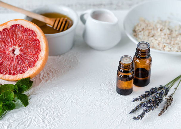 DIY cosmetics and spa. ingridients for homemade beauty facial mask. essential oil, mint, aloe, honey, milk, lavender, rosehip, oatmeal, coffee beans and grapefruit.  - Photo, Image