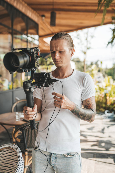 Professional man videographer with stabilizer gimball video slr - Photo, image