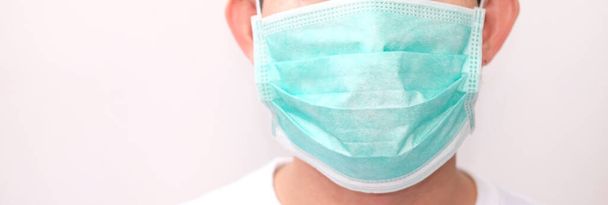 Protection against contagious disease, coronavirus. Man wearing hygienic mask to prevent infection, airborne respiratory illness such as flu, 2019-nCoV. indoor studio shot isolated on white background - Foto, Imagen