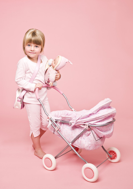 Young girl with baby stroller - Φωτογραφία, εικόνα