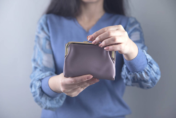 woman hand holding wallet on grey background - Zdjęcie, obraz