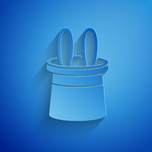 Paper cut Magician hat and rabbit ears icon isolated on blue background. Magic trick. Mystery entertainment concept. Paper art style. Vector Illustration - Vector, Image