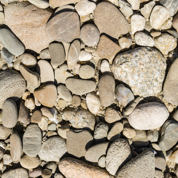 Un modello di ciottoli-pietra che crea una texture naturale sul terreno
. - Foto, immagini