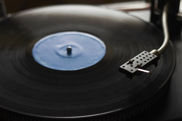 Close-up van blauwe muziek record op draaitafel, draaitafel naald afspelen van muziek, selectieve focus - Foto, afbeelding
