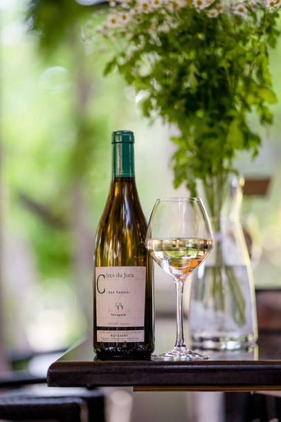 Bottle of white wine on summer terrace - 写真・画像