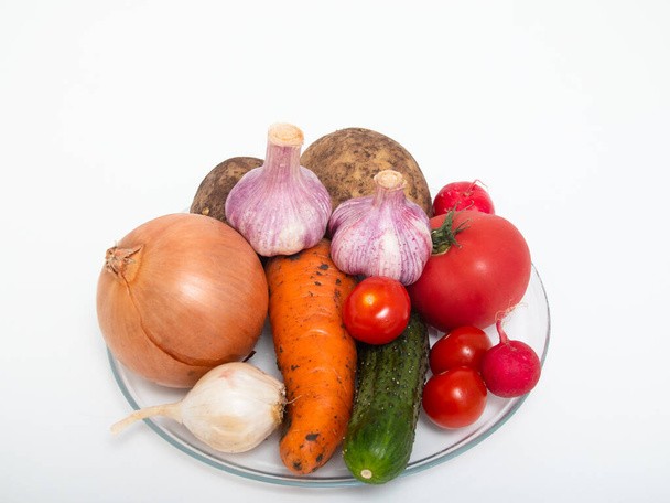 Assortment of fresh vegetables on a transparent plate on the table - Fotografie, Obrázek