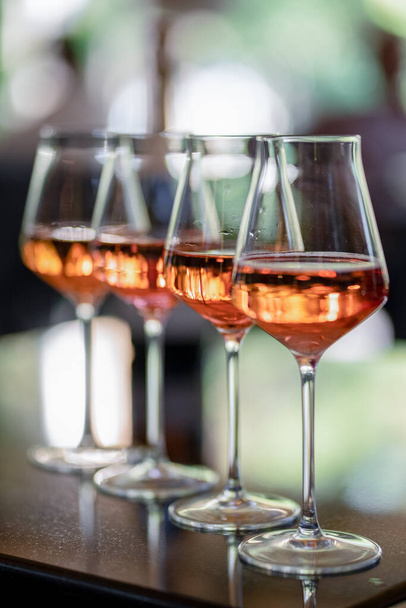 Glasses of rose wine on summer terrace - 写真・画像