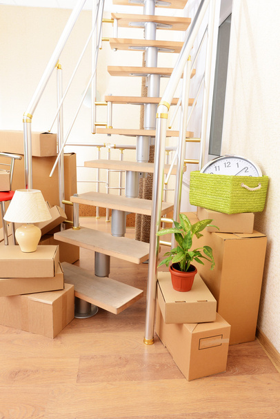 Stack of cartons near stairs: moving house concept - Photo, Image