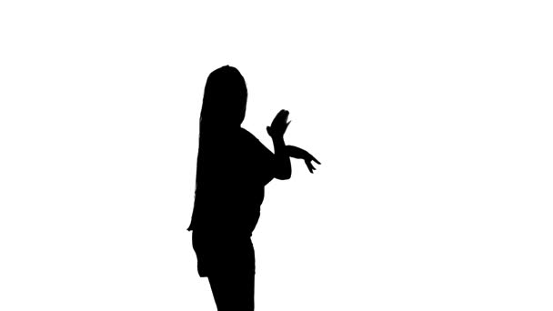 Средний снимок молодой красивой девушки с длинными волосами, танцующей танец живота, восточный танец, экзотический танец, черный силуэт на белом фоне
 - Кадры, видео