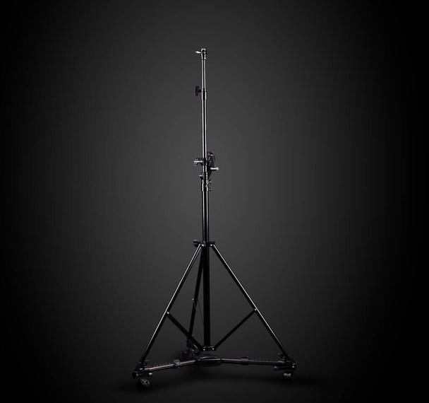 Photo studio lighting stands isolated on the black background. - Photo, Image