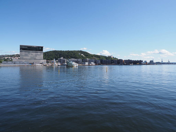 Modern buildings at fjord in european capital city of Oslo at Ostlandet district in Norway, clear blue sky in 2019 warm sunny summer day on July. - Valokuva, kuva