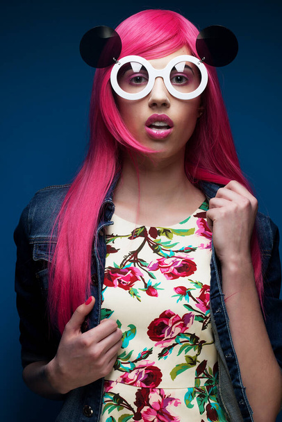 fashion girl with pink hair and big sunglasses over blue background - Φωτογραφία, εικόνα