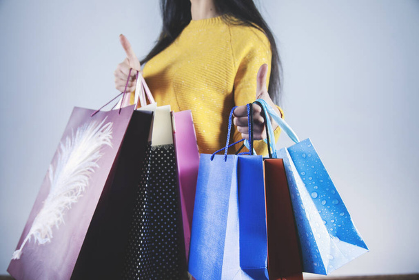 woman hand colorful shopping bags on gray background - Valokuva, kuva