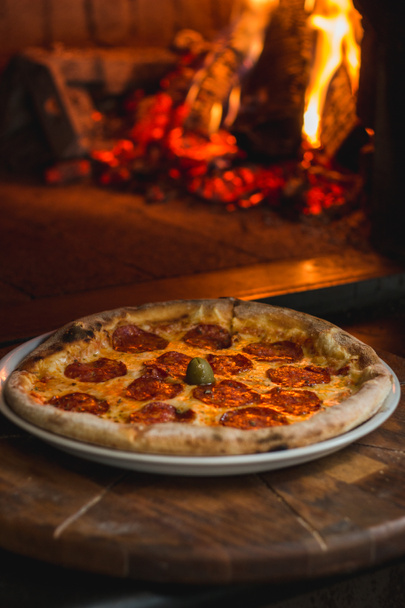 Photo of delicious fresh pizza straight out of the fire place - Photo, Image