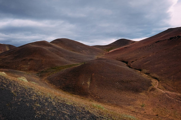 brown rock hills as a result of prehistoric volcanic activity in Iceland - Photo, Image