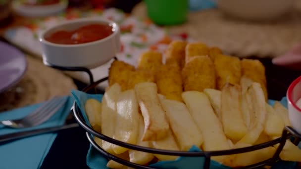 dinner table with fries and ketchup, mayo sauces, delicious grilled meat, russian salad, delicious meatballs dressed with onions, seasonings and parsley close up - Footage, Video