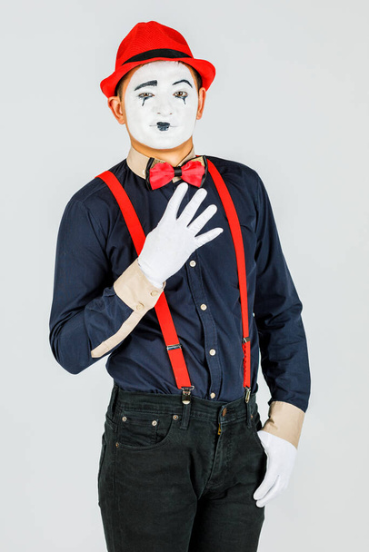 Clown with red suspenders and red hat on white background. - Fotoğraf, Görsel