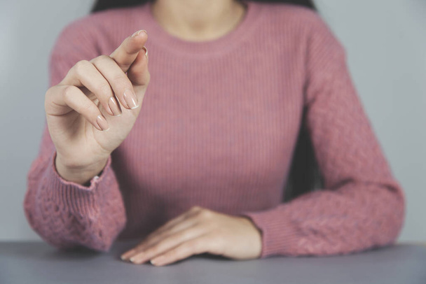 woman finger touching in screen on the desk background - Photo, image
