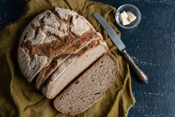 Homemade reshly baked country bread made from wheat and whole grain flour sliced with butter - Foto, Imagem